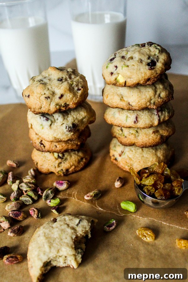 Cranberry, Raisin and Pistachio Cookies Recipe 5 Stacks of cranberry raisin pistachio cookies with glasses of milk