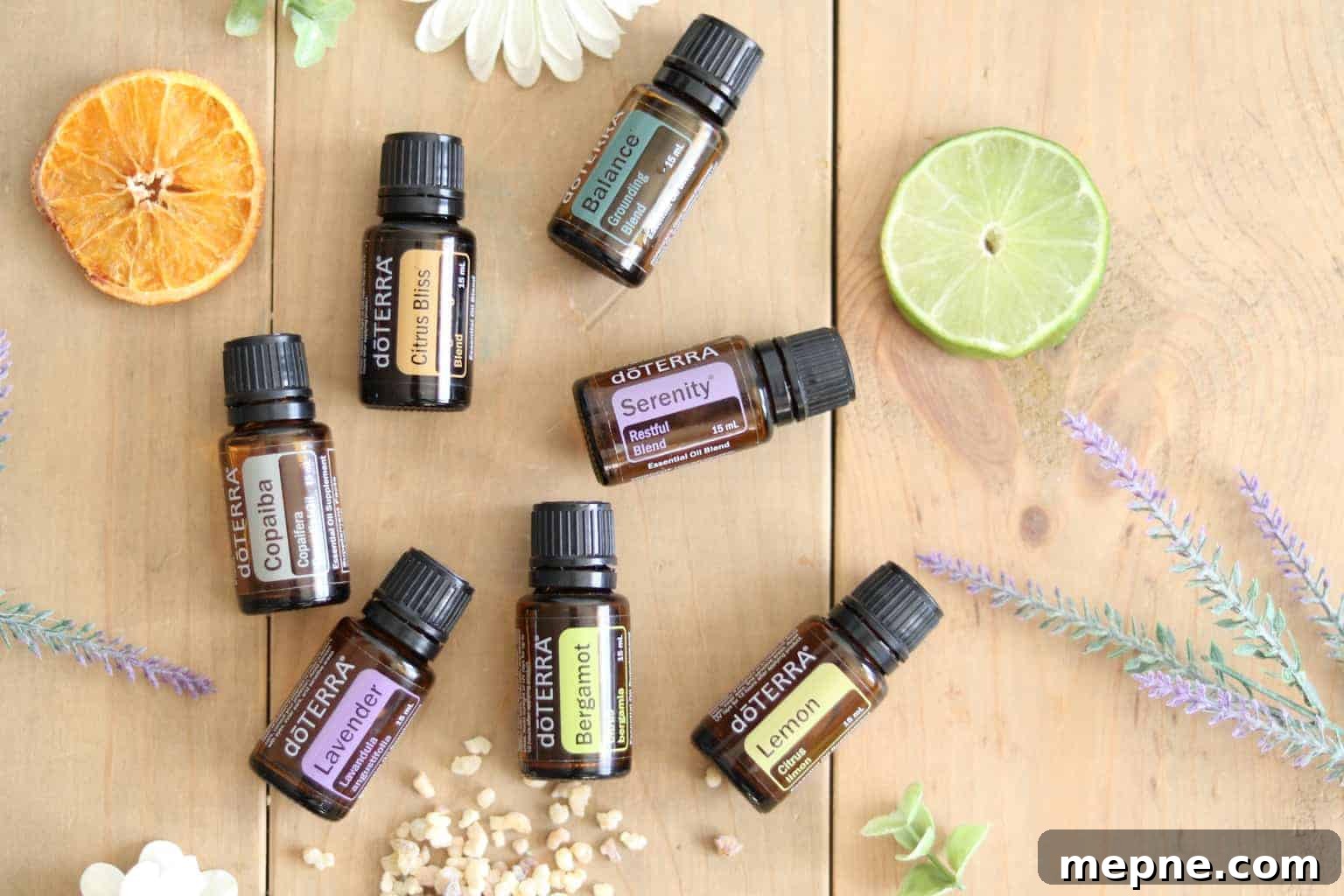 Essential Oils for Stress Relief and Anxiety 3 Essential oil roller bottles with dried flowers and fruits on wooden table.