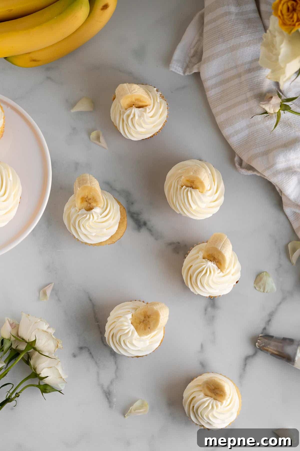 Creamy Banana Pudding Cupcakes with Vanilla Frosting 3 overhead shot of banana pudding cupcakes on a marble background
