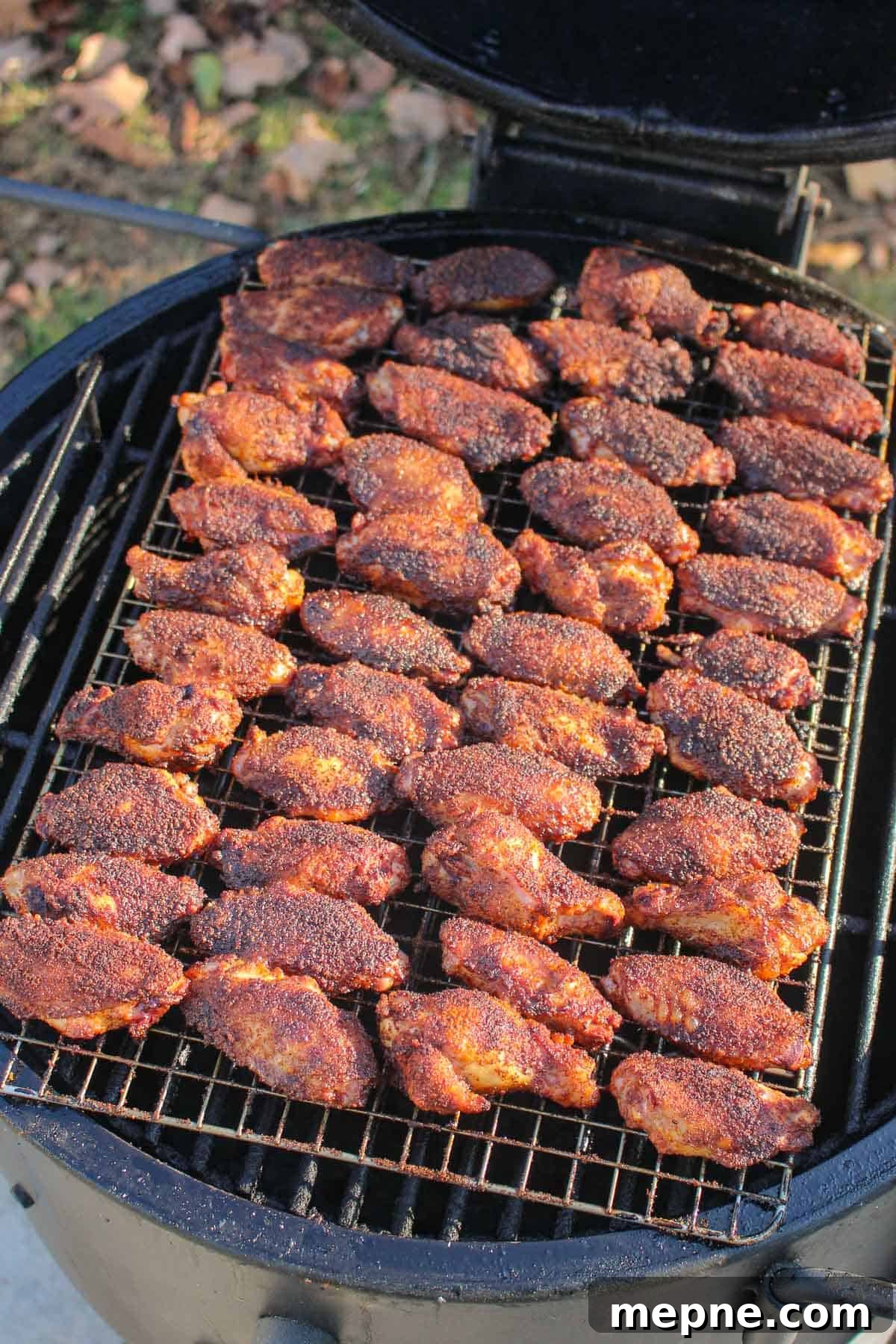 The cooked Nashville Hot Chicken Wings ready to be removed from the smoker.