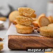 French financiers with almonds on a wooden board lined with parchment.
