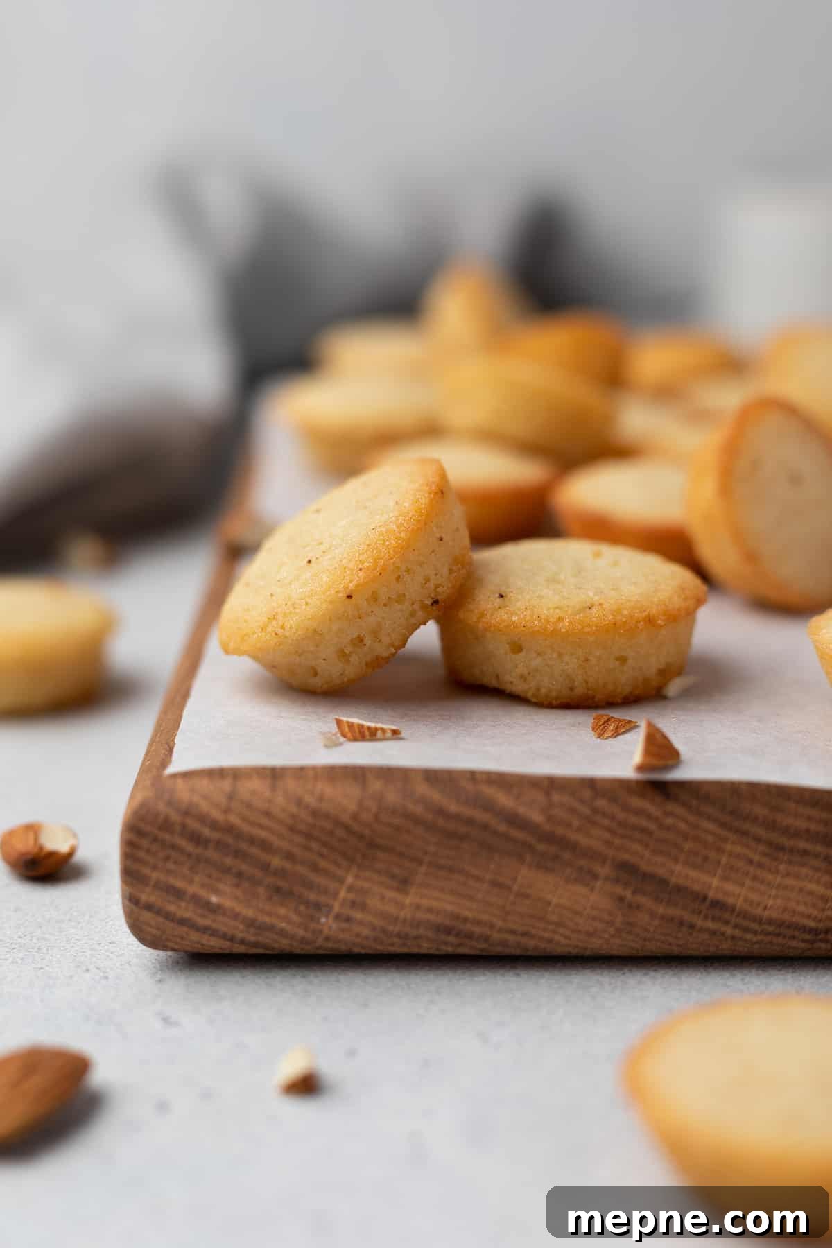 Authentic French Financiers Recipe: Classic Almond Tea Cakes 3 A batch of brown butter financiers on a wooden board