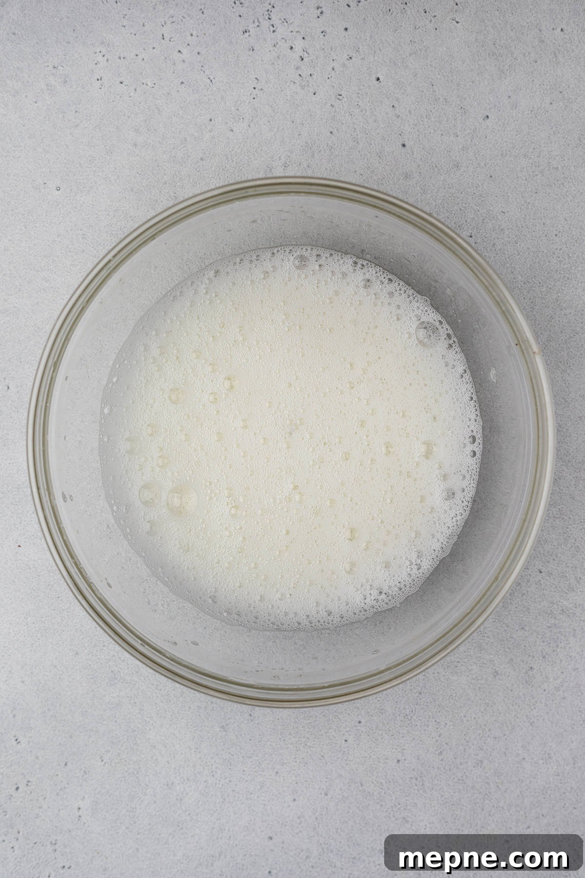 Authentic French Financiers Recipe: Classic Almond Tea Cakes 6 Beaten egg whites in a glass bowl