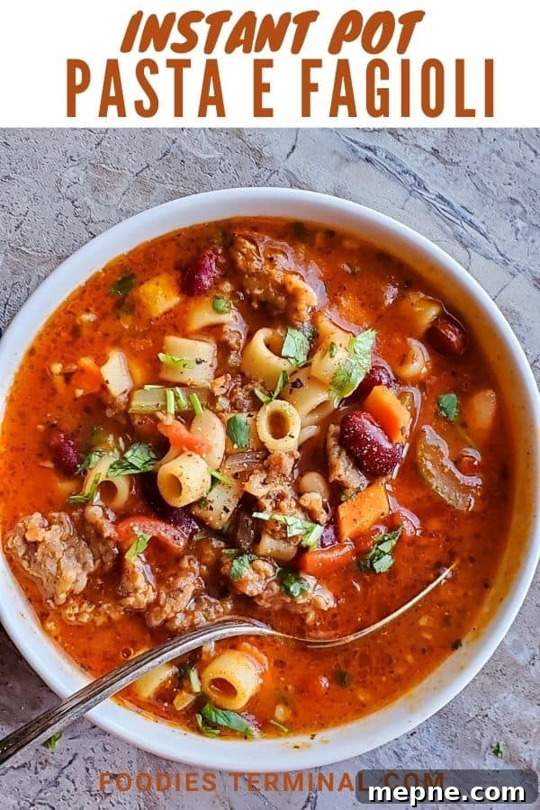 Instant Pot Olive Garden Copycat Pasta e Fagioli Recipe 8 pasta e fagioli soup in a white bowl with a spoon