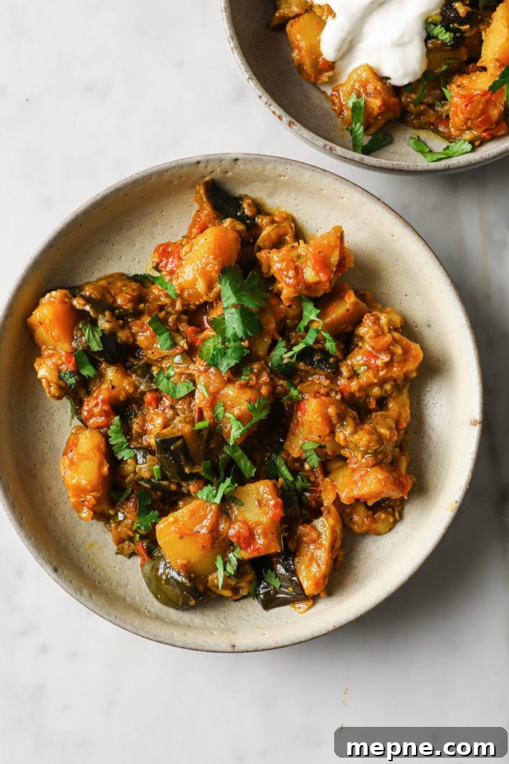 Aloo Baingan: Indian Eggplant and Potato Curry 11 Aubergine and potato curry in a bowl