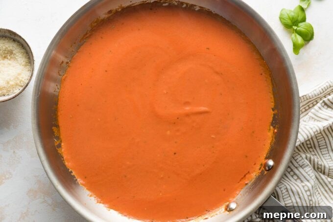 Homemade tomato cream sauce for pasta in a medium skillet.