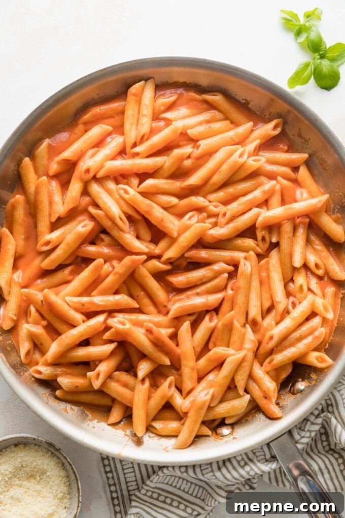 Creamy tomato pasta tossed together in a skillet.