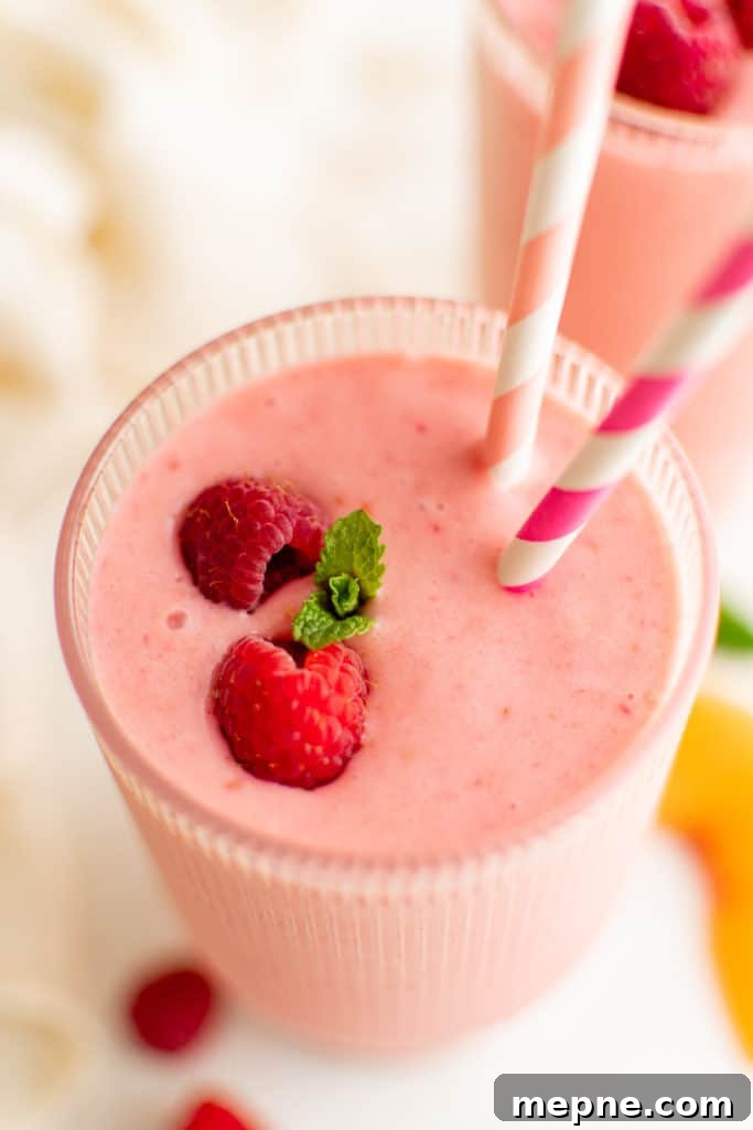 Creamy Peach and Raspberry Smoothie Recipe 4 Top down view of fresh fruit on a smoothie.