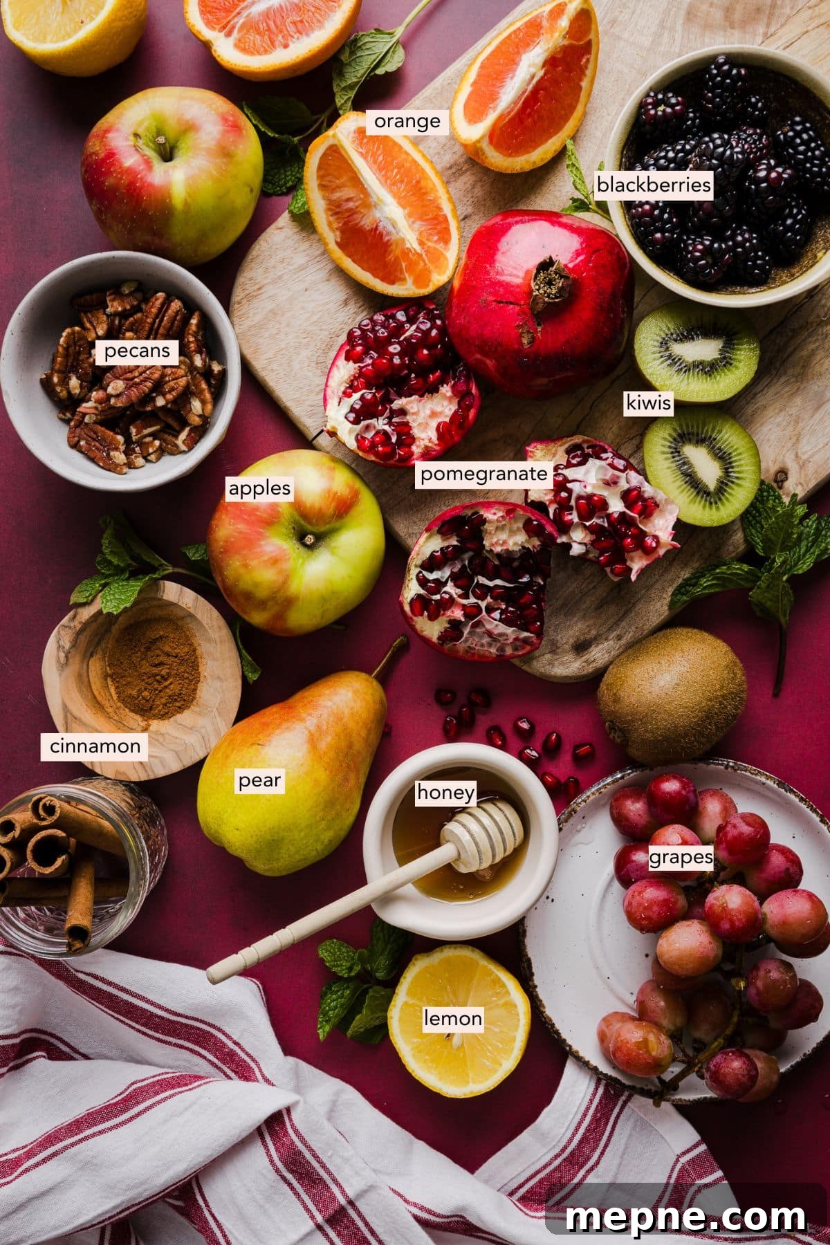 Ingredients for a thanksgiving fall fruit salad on a countertop with labels.