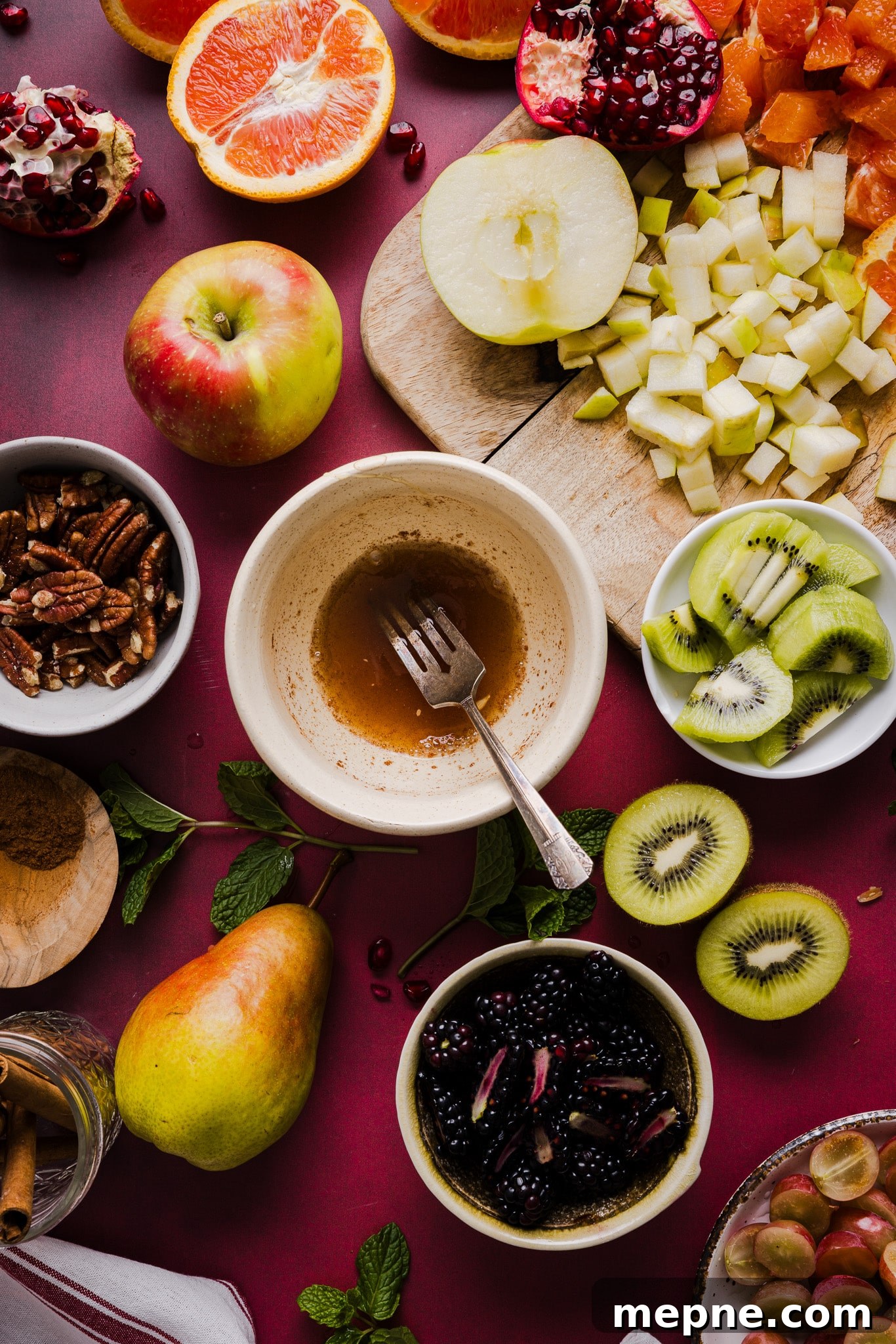 Honey, cinnamon and lemon juice being mixed together in a small bowl for fall fruit salad.