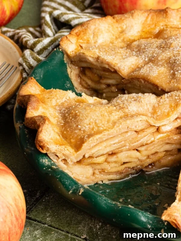 Healthy apple pie sliced in a pie dish.