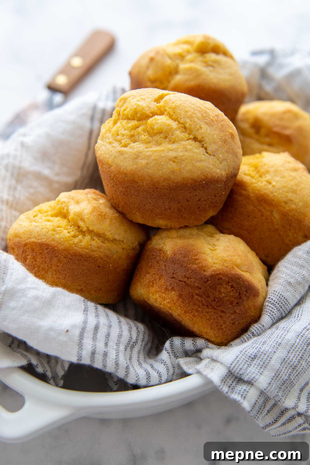 Moist Gluten Free Corn Muffins Recipe 2 a basket of corn muffins lined with a white towel