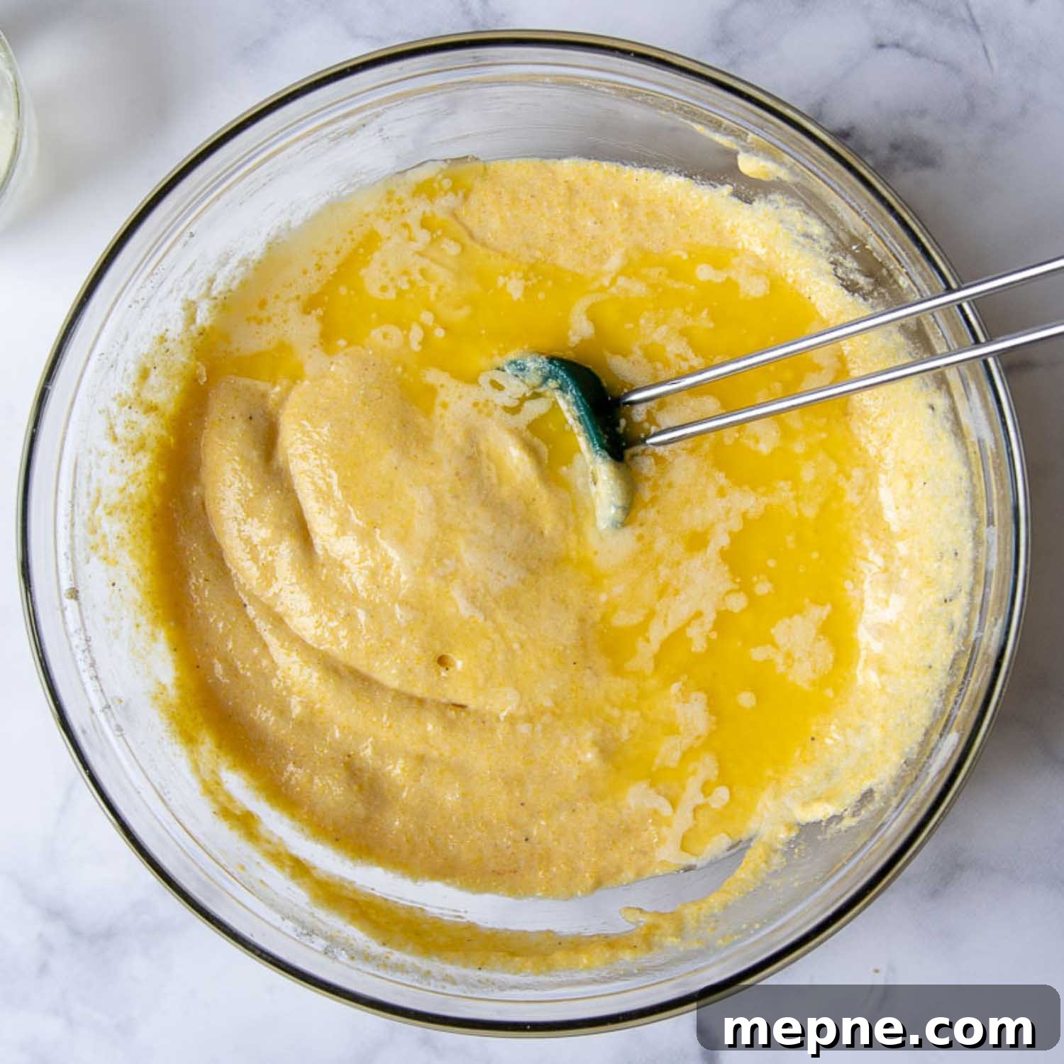 Moist Gluten Free Corn Muffins Recipe 5 melted butter being stirred in.