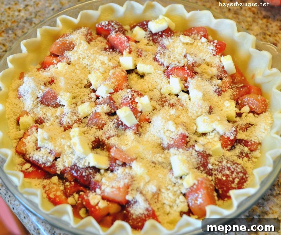 Baked strawberry rhubarb pie cooling on a wire rack.
