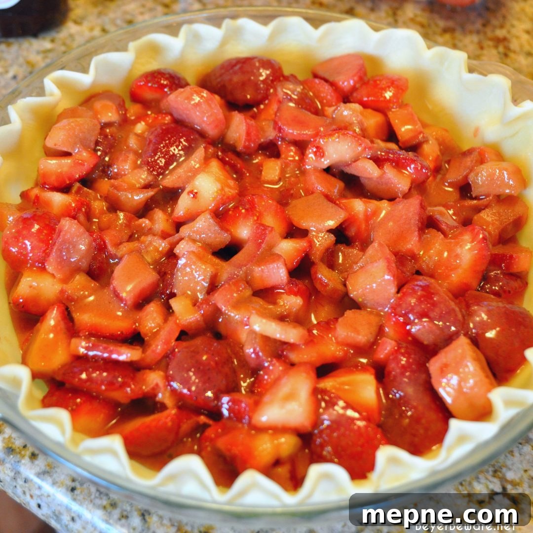 Fruit filling in pie crust ready for crumb topping.