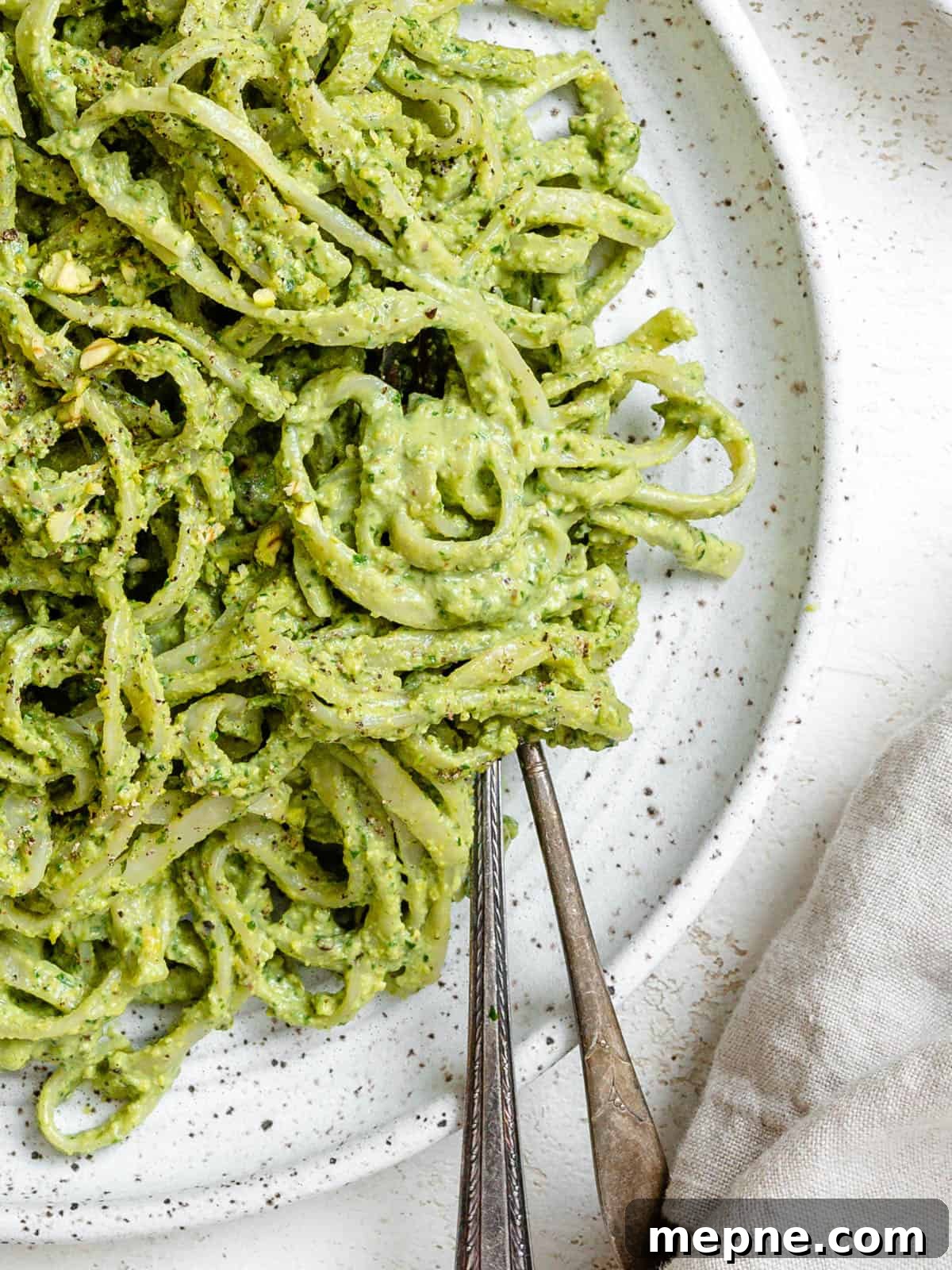 Creamy Avocado Pesto Pasta Recipe 2 completed Amazing Avocado Pesto Pasta plated against a light surface