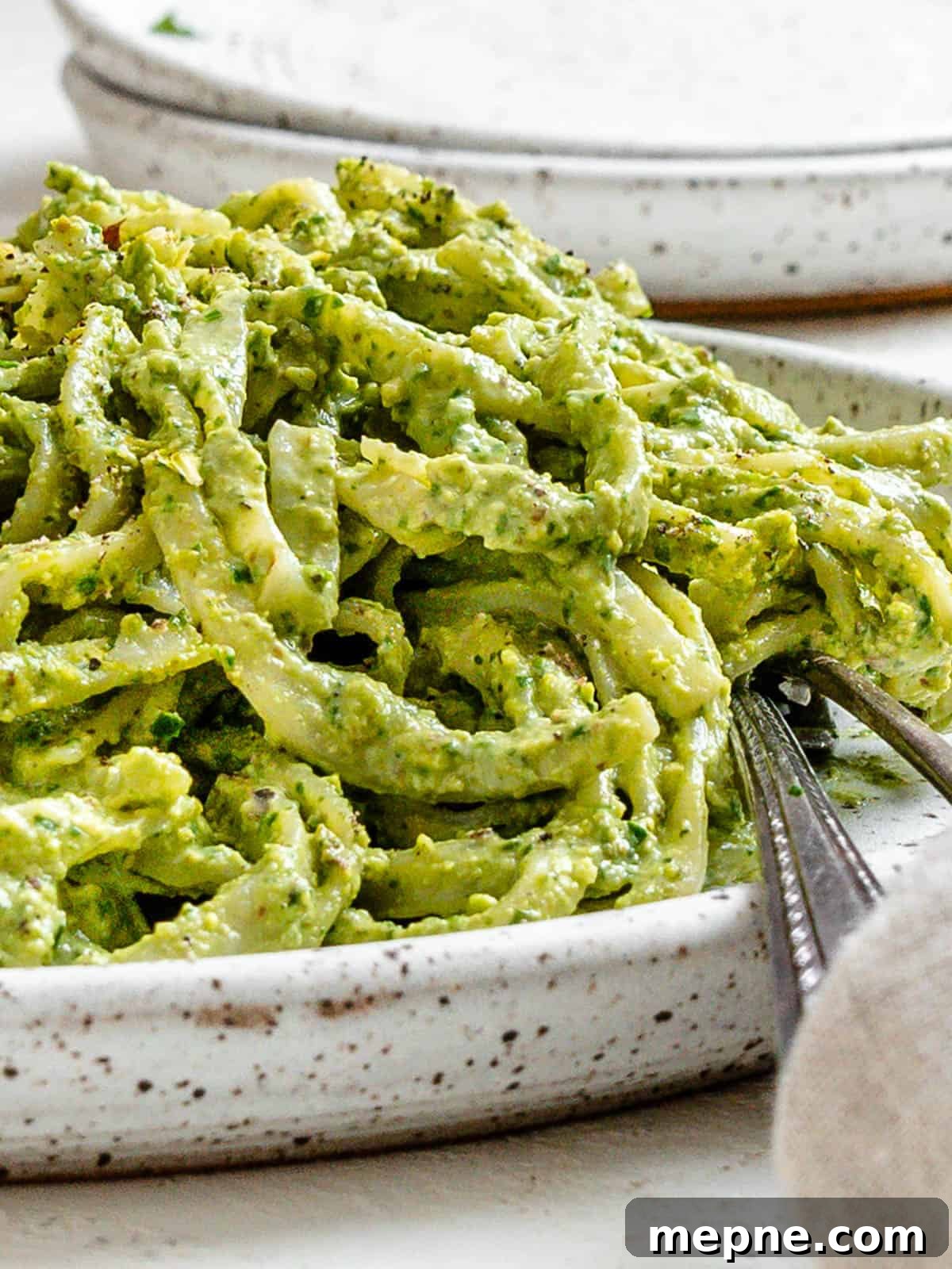 Creamy Avocado Pesto Pasta Recipe 8 completed Amazing Avocado Pesto Pasta plated against a light surface