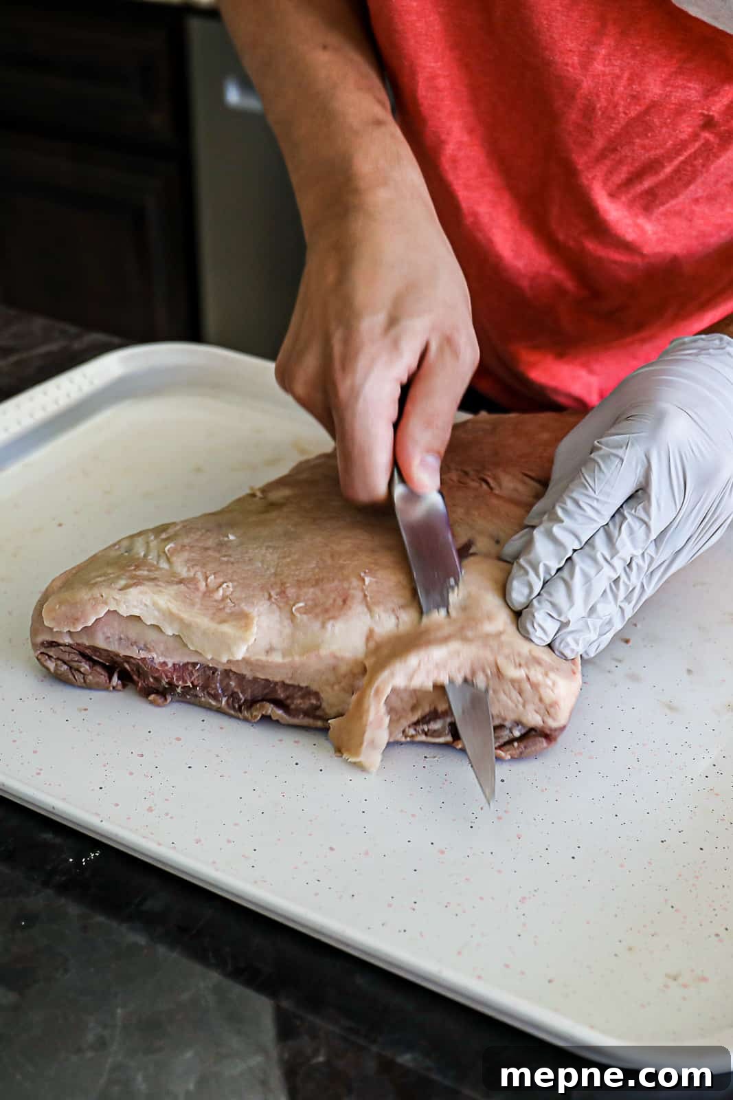 Demonstrating Trimming Brisket before cooking it
