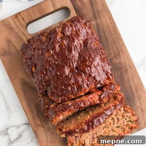 Smoked Side Dishes for BBQ and Cookouts 13 Sliced meatloaf on a cutting board with a knife