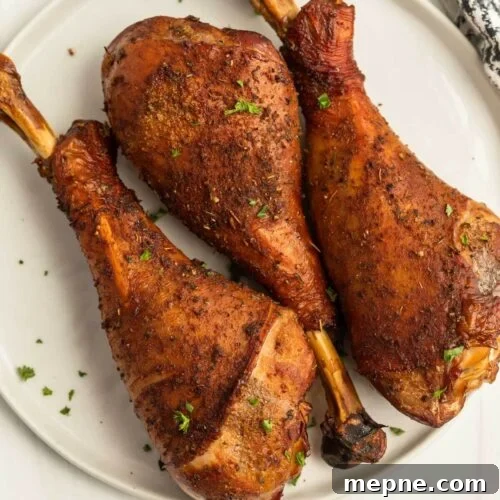 Smoked Side Dishes for BBQ and Cookouts 16 Three turkey legs on a white plate