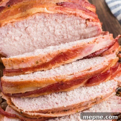 Smoked Side Dishes for BBQ and Cookouts 17 Sliced bacon wrapped pork loin on a cutting board