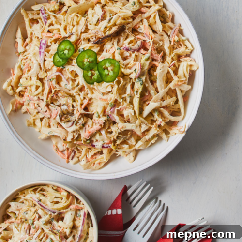 Smoked Side Dishes for BBQ and Cookouts 37 A bowl of cole slaw with a fork and knife