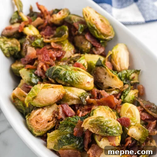 Smoked Side Dishes for BBQ and Cookouts 6 A white bowl filled with brussels sprouts and bacon