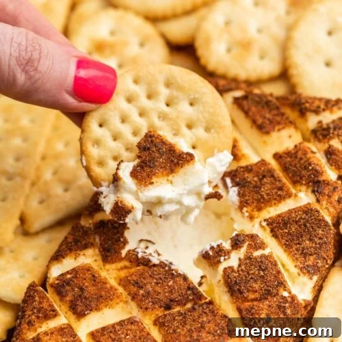 Smoked Side Dishes for BBQ and Cookouts 7 A hand dipping crackers into a cream cheese dip