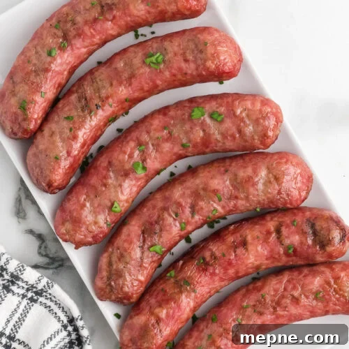 Smoked Side Dishes for BBQ and Cookouts 8 Six sausages on a white plate with parsley