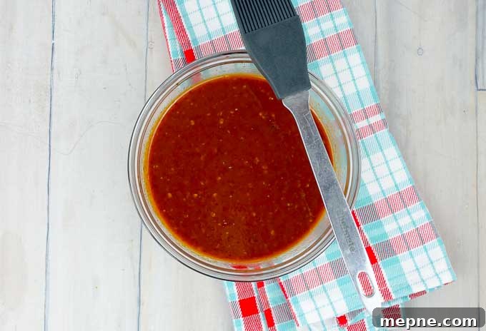 Homemade Chipotle Brown Sugar BBQ Sauce Recipe 3 Homemade Chipotle Brown Sugar Barbecue Sauce in a glass bowl with a basting brush