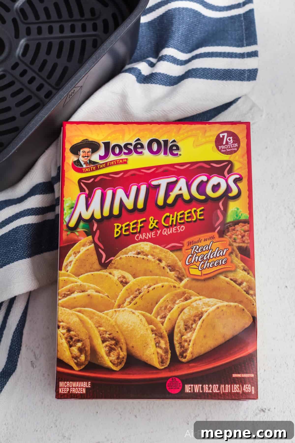 Air Fryer Frozen Mini Tacos: Crispy in Minutes 3 Box of Jose Ole frozen mini tacos made with beef and cheese in the box on a counter with a towel and the basket of the air fryer.