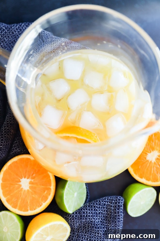 Spiced Rum Punch Recipe with Citrus and Warm Spices 4 making spiced rum punch in a pitcher