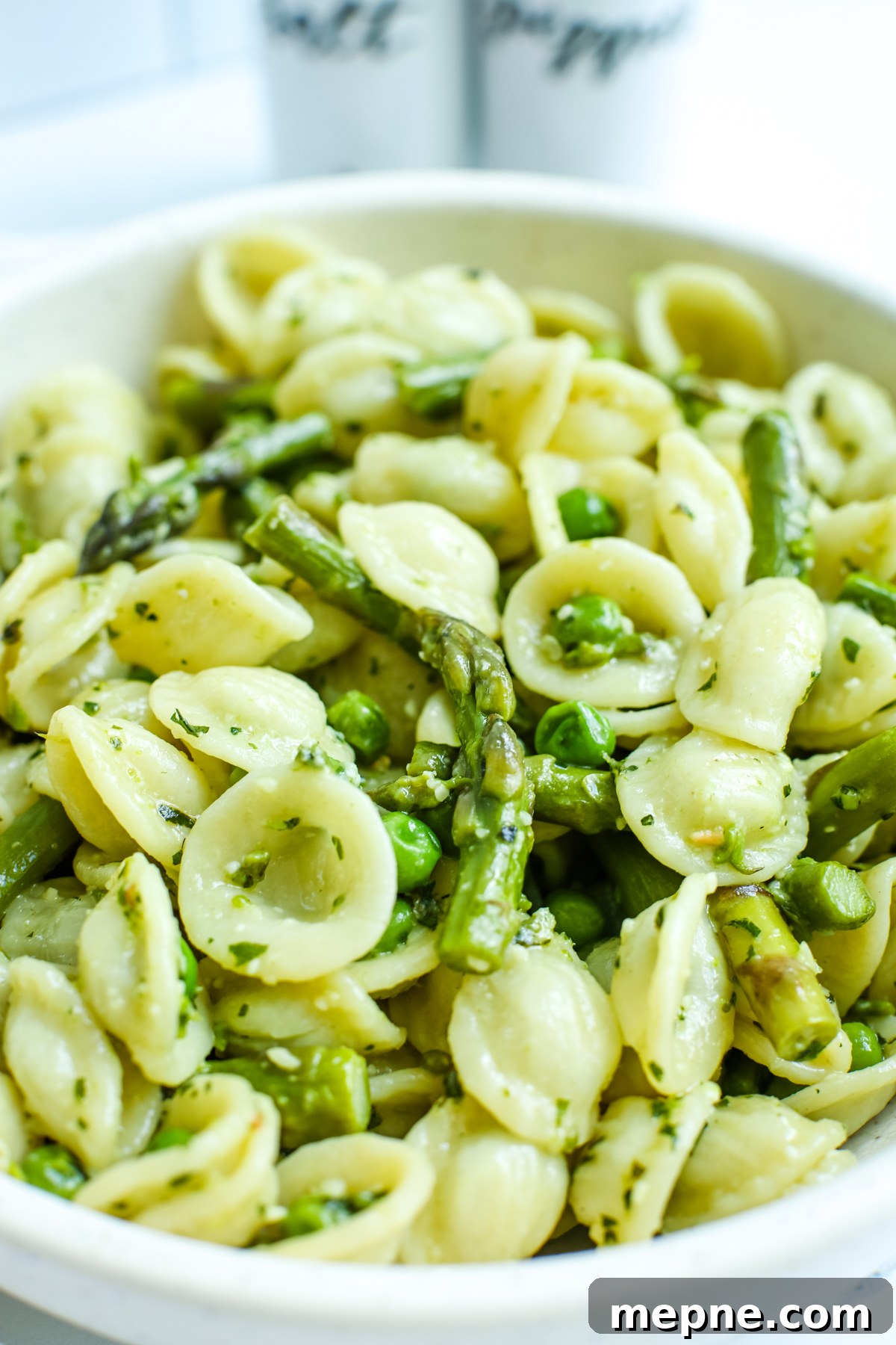 Orecchiette with Pesto, Asparagus and Spring Peas 2 Orecchiette Pasta with asparagus, peas, and pesto in a bowl close up photo