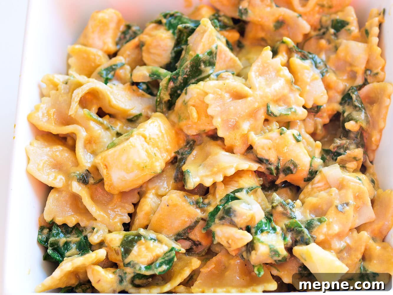 Orecchiette with Pesto, Asparagus and Spring Peas 7 a close up shot of spinach artichoke pasta with chicken