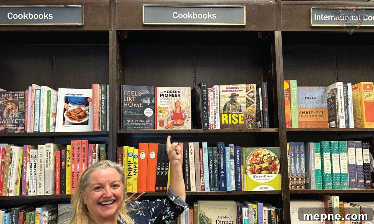 Modern Pioneer Cookbook Makes Publishers Weekly Bestseller List 4 Mary pointing at her cookbook on the shelves at Barnes and Noble.