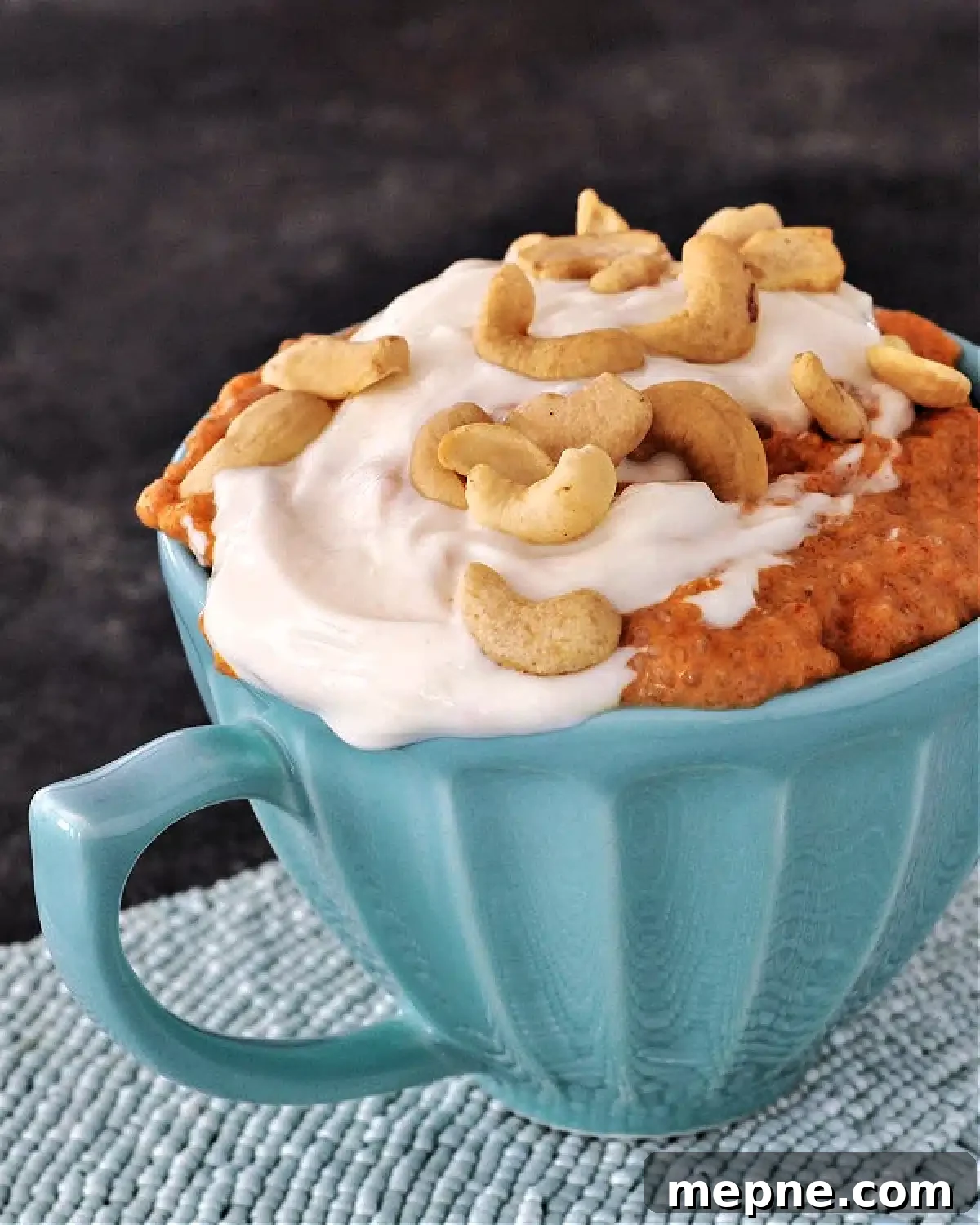 Savory Red Curry Chia Pudding @spabettie #glutenfree #lowcarb #vegan #dairyfree #recipe Savory red curry chia pudding and cashew cream, topped with cashews, served in a teal mug.