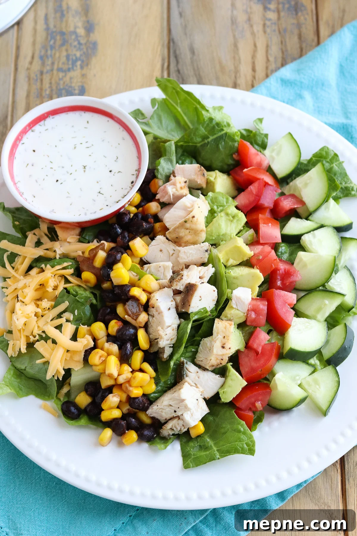 Grilled Chicken Fajita Salad Recipe with Avocado & Lime 3 Top view of a bowl of salad with black bean salsa, grilled chicken, tomatoes and avocado
