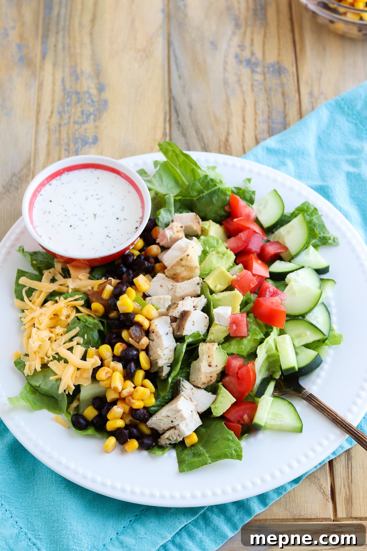 Grilled Chicken Fajita Salad Recipe with Avocado & Lime 5 Plated chicken fajita salad with black bean corn salsa, avocado and cheese