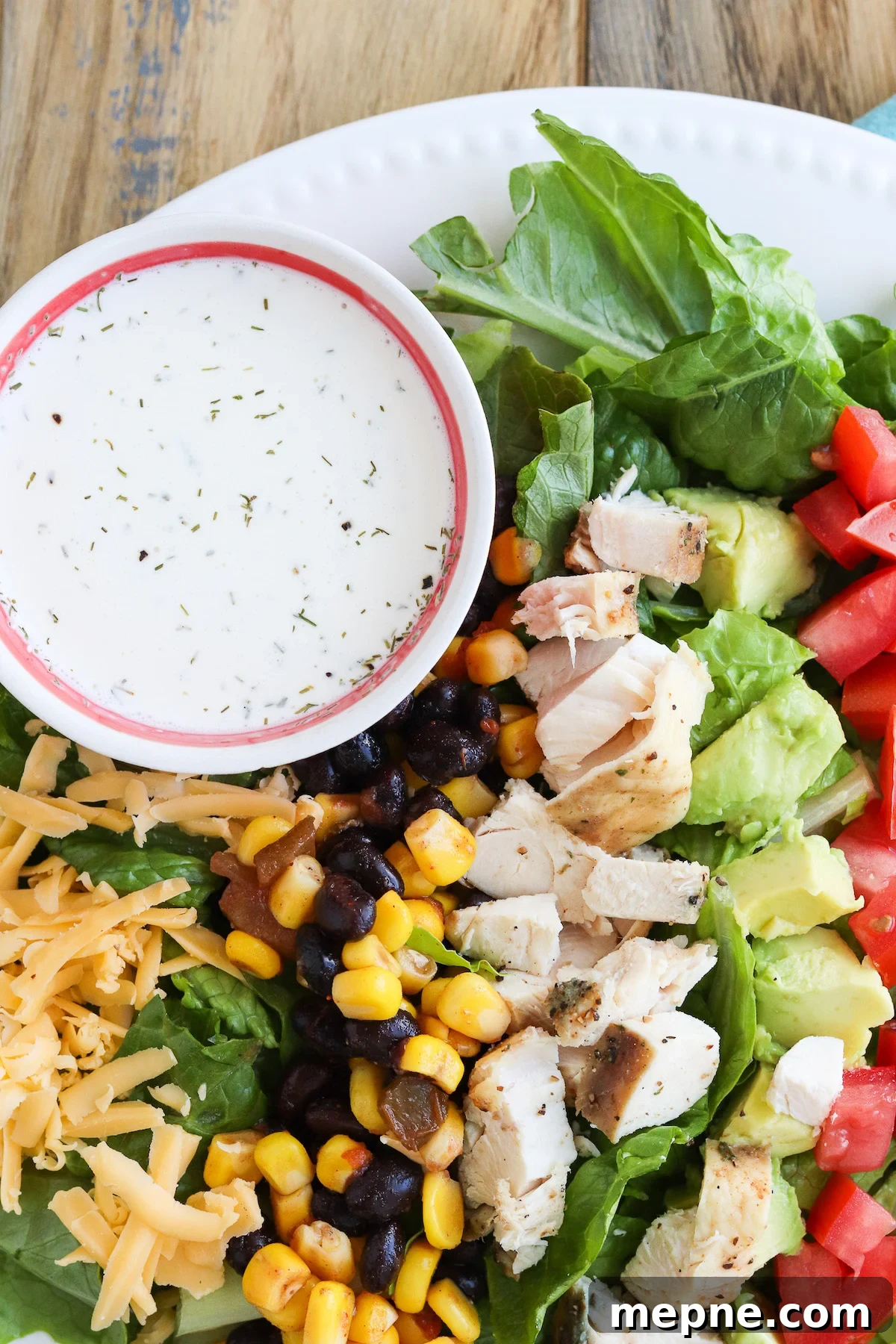 Grilled Chicken Fajita Salad Recipe with Avocado & Lime 6 End plate view of chicken fajita salad showing avocado and cheese