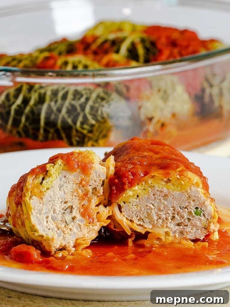 inside of easy stuffed cabbage rolls with meat filling on a white plate covered in a red tomato sauce