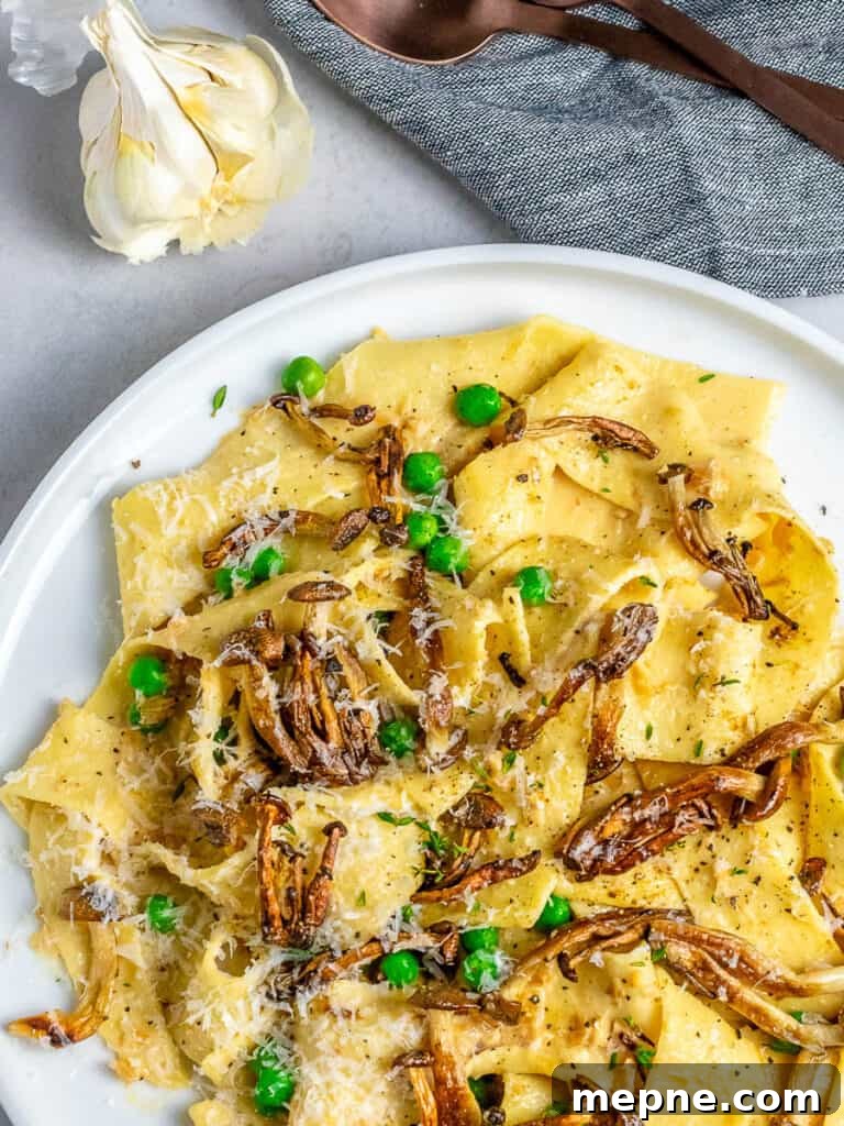 mushroom pappardelle pasta recipe on white plate and garlic