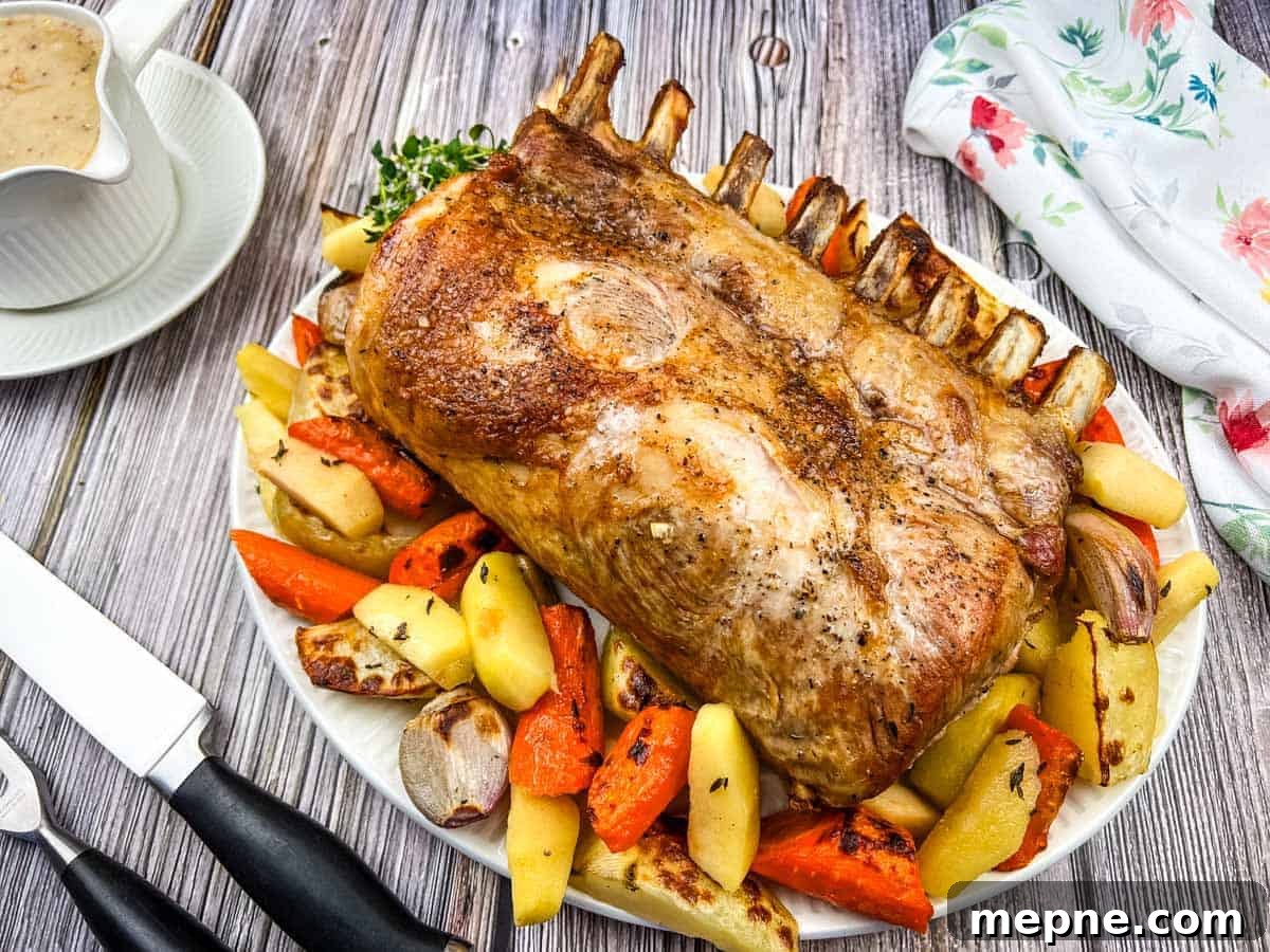 31 Southern Recipes That Belong in Your Dinner Rotation 18 A plate of Pork Roast with Apples on a table.