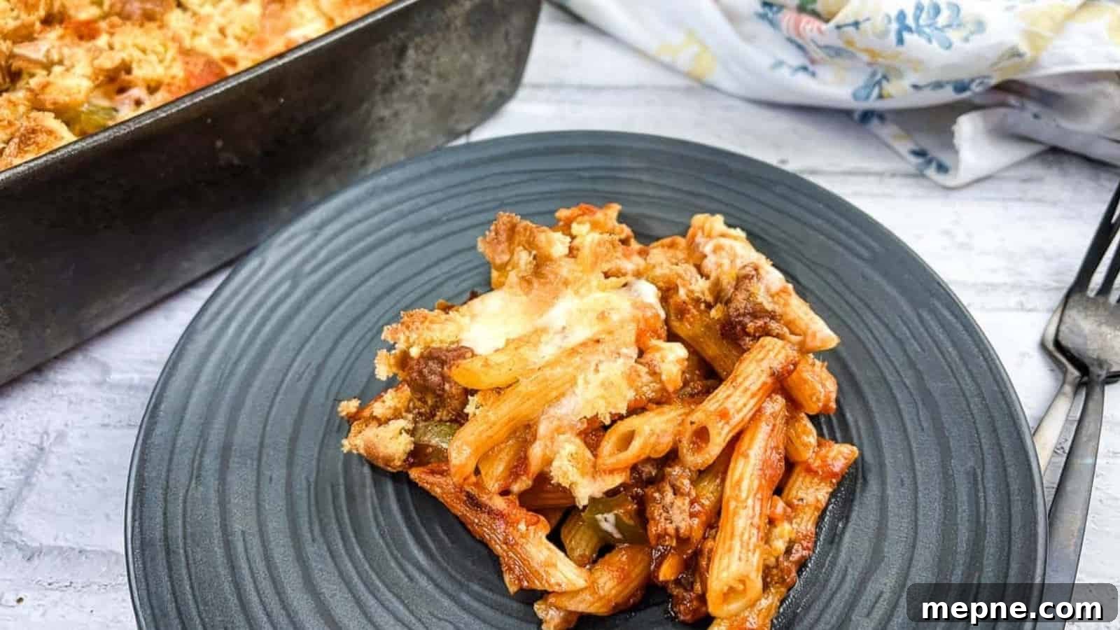 31 Southern Recipes That Belong in Your Dinner Rotation 26 A serving of Sloppy Joe Casserole pasta with meat on a plate with a fork.