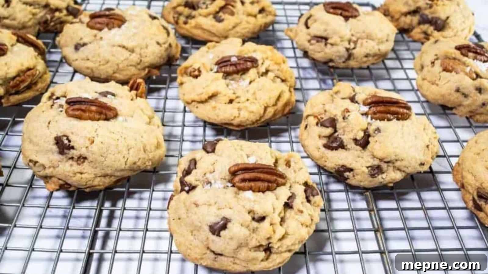 31 Southern Recipes That Belong in Your Dinner Rotation 31 Chocolate chip cookies with pecan halves on top are cooling on a metal wire rack.