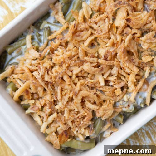 green bean casserole topped with fried onions in a casserole dish.