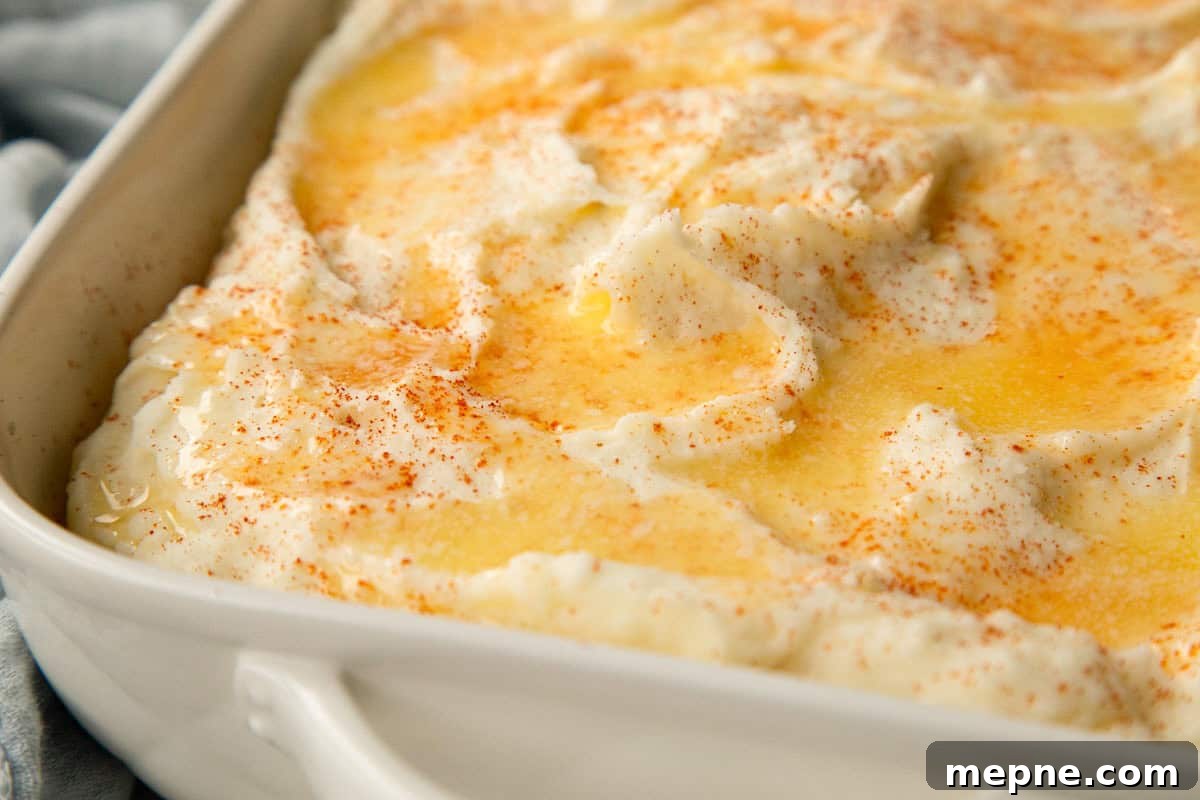 baked mashed potatoes topped with melted butter and paprika.