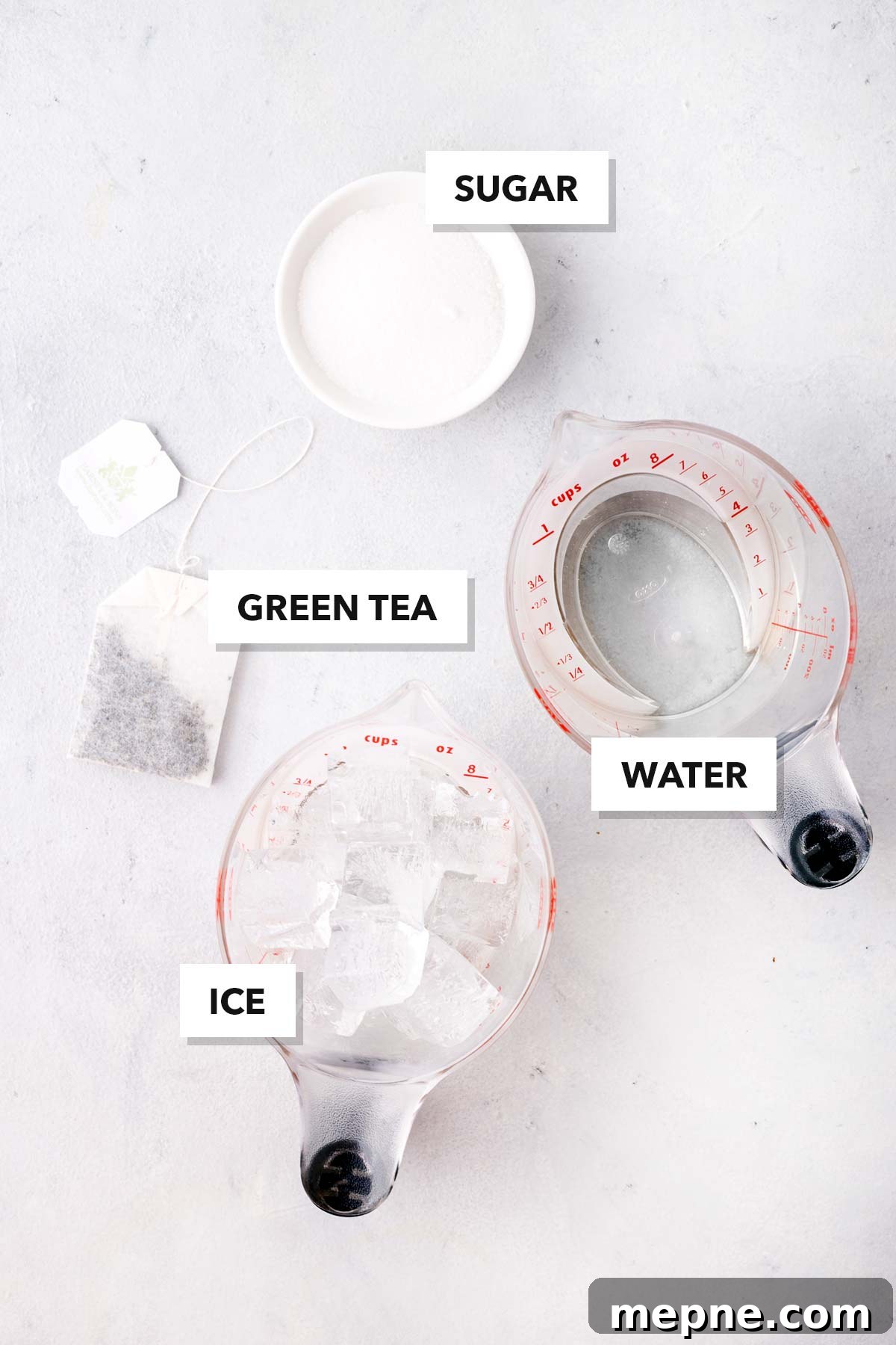 How to Make Iced Green Tea at Home 3 Iced Green Tea ingredients measured in cups and labeled on a table.