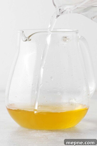 How to Make Iced Green Tea at Home 6 Pouring water into a tea pot with tea.