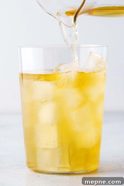 How to Make Iced Green Tea at Home 7 Pouring tea into a cup with ice.