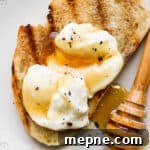Honey Whipped Ricotta Spread for Toasts and Fruit 7 Grilled bread with whipped ricotta on top and some honey on a plate.